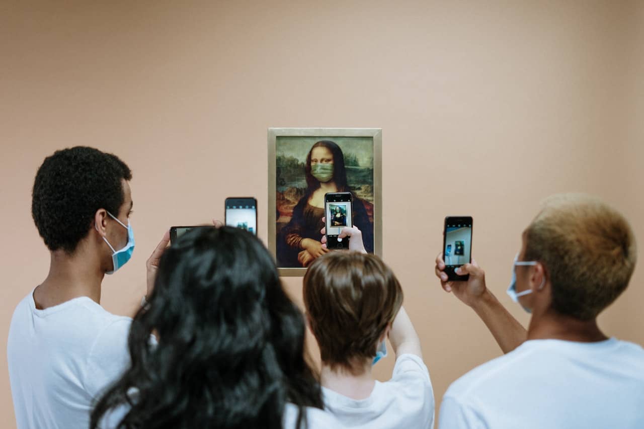 people-taking-picture-of-a-painting-of-mona-lisa-with-face-3957980